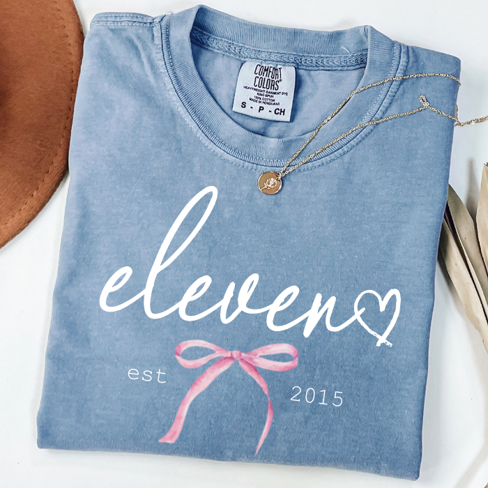 Blue Comfort Colors eleven birthday shirt for girls with elegant script lettering and boutique birthday style