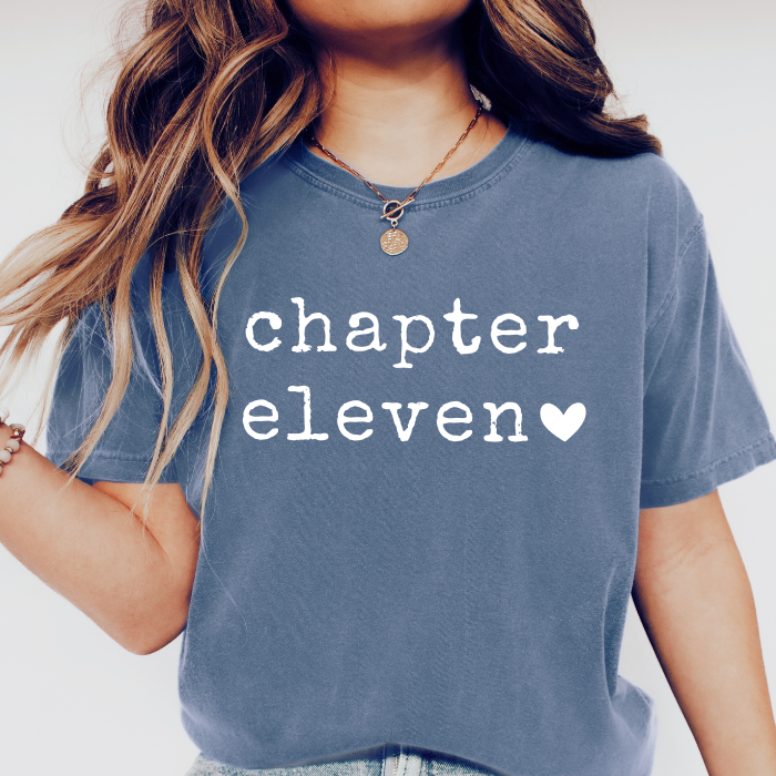 Female girl wearing blue Comfort Colors Chapter Eleven 11th birthday shirt with vintage white typography