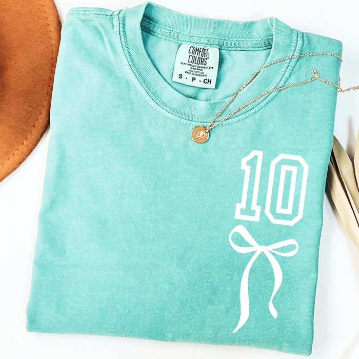 Mint Comfort Colors 10th birthday shirt featuring white number 10 and coquette bow graphic