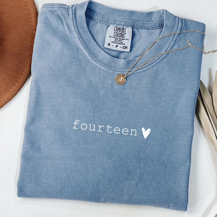 blue jean comfort colors shirt that says fourteen with a chalk heart